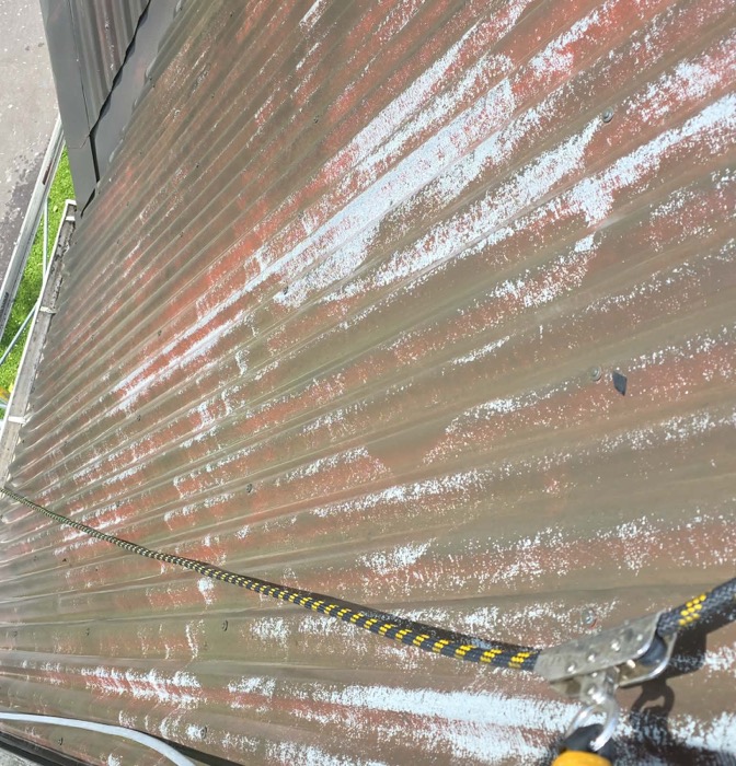 Old paint peeling and flaking off a roof